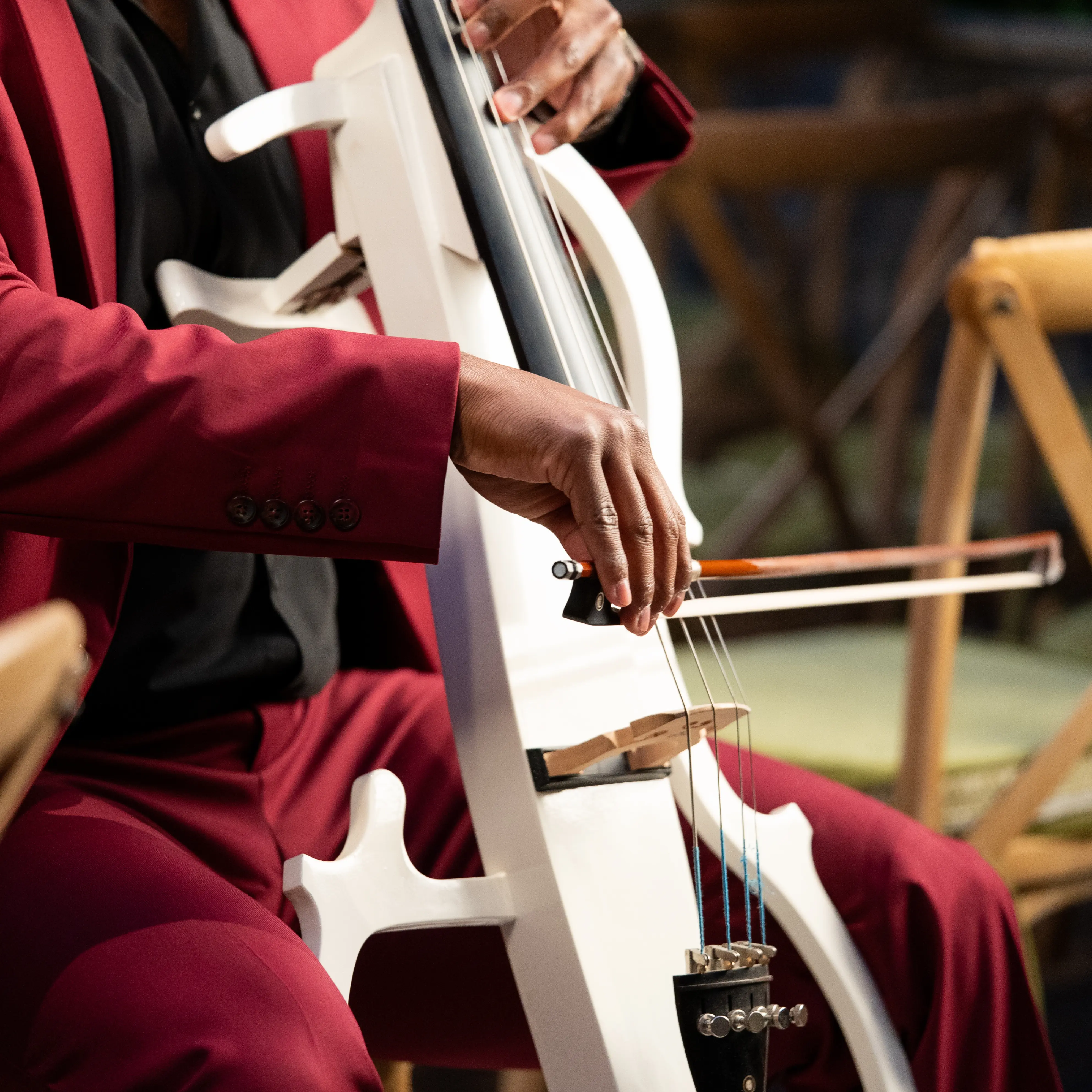 A cello resting against a chair